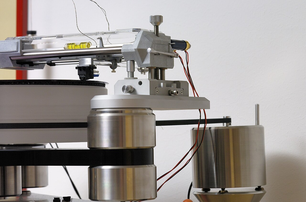 A belt-drive turntable with platter, tonearm and counterweight.